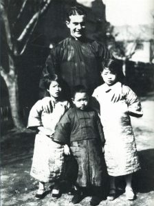 Ed Snow standing with with Chinese kids